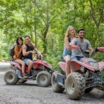 young couple or friend happy while riding an ATV